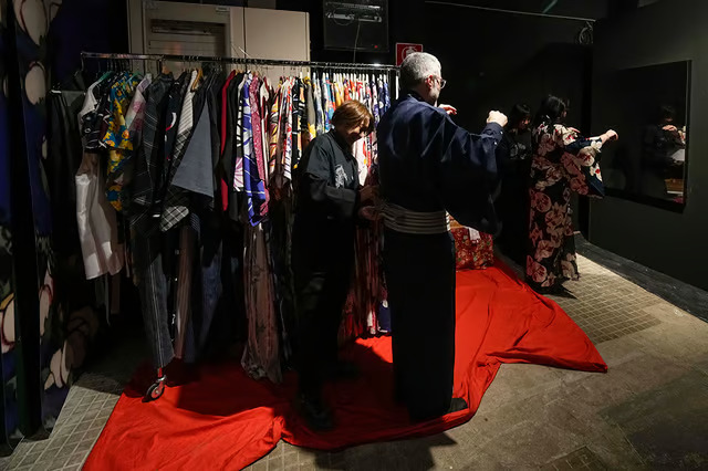Visitors get dressed in a Kimono - Ukiyoe Immersive Art exhibition _ Photo- AP-Luca Bruno